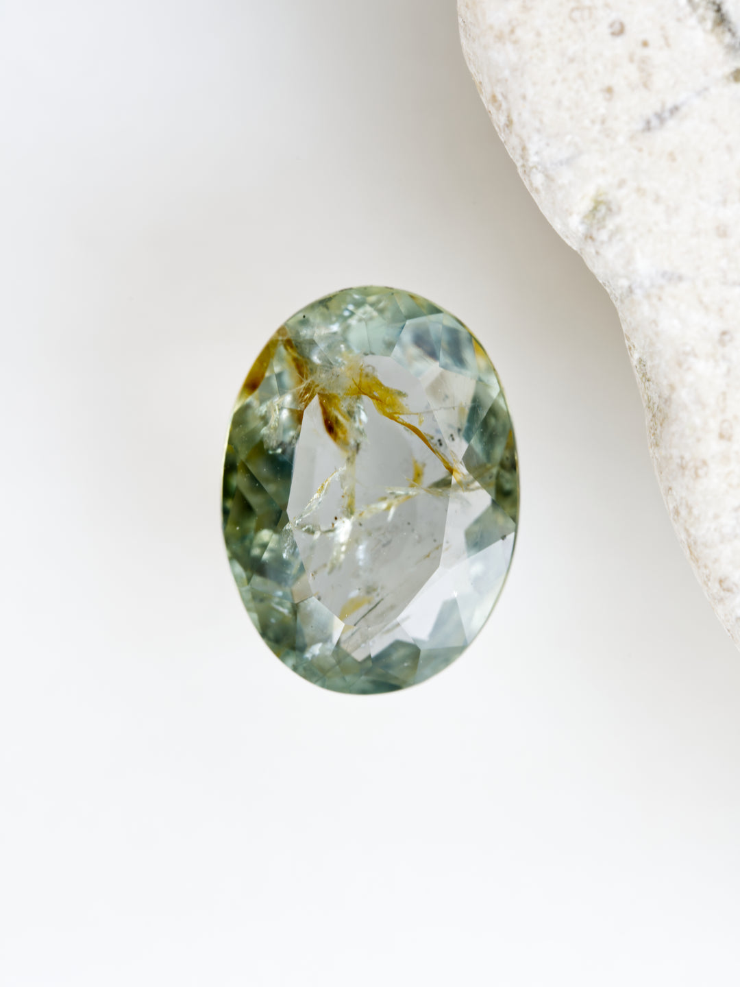 Oval-shaped gemstone on a white background
