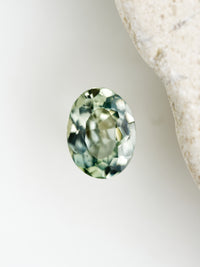 Oval-shaped green gemstone on a white background